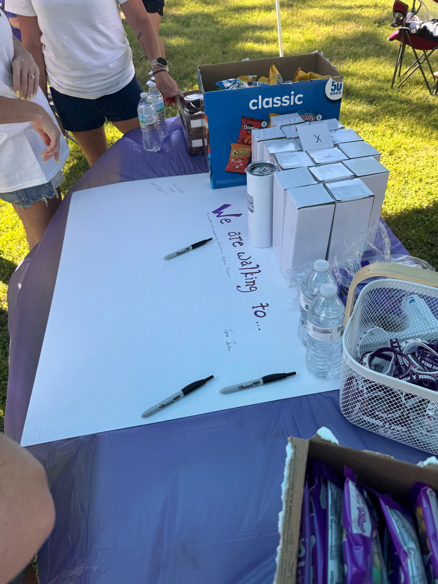A 'We are walking to…' signature banner on a purple table